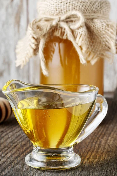 Glass gravy boat with honey. — Stock Photo, Image