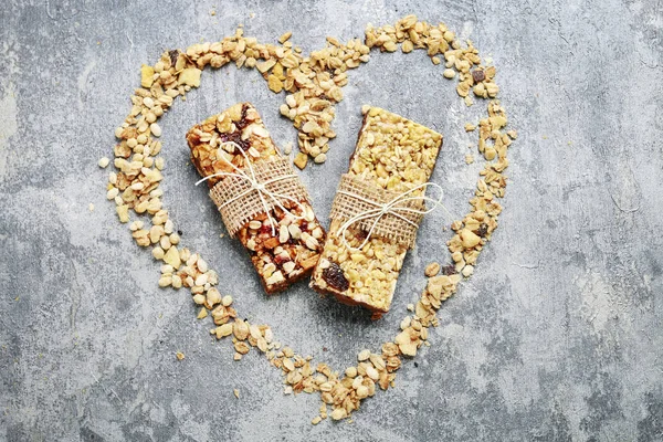 Two muesli bars on grey stone background. — Stock Photo, Image