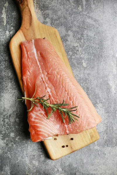 Raw salmon fillet on grey stone background — Stock Photo, Image