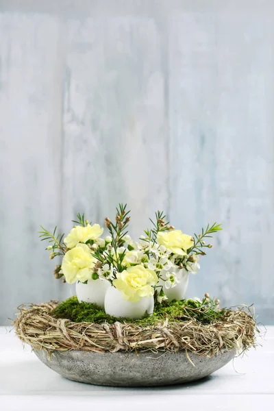 Pièce maîtresse de table de Pâques avec œillets, fleurs de cire, mousse et — Photo