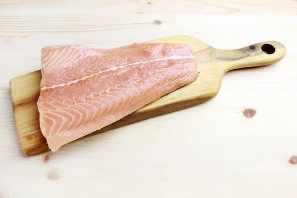 Raw salmon filet on wooden background — Stock Photo, Image