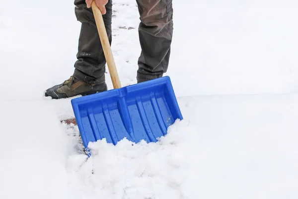 Hombre quitando nieve de la acera después de la tormenta de nieve . — Foto de Stock