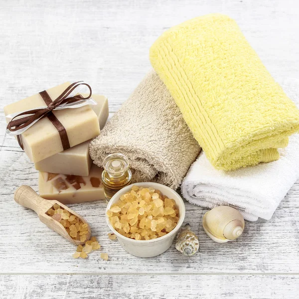 Spa set: soft towels, bar of soap and bowl of sea salt.