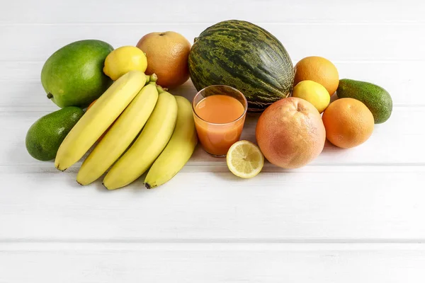 Various fruits on white wooden background. — Stock Photo, Image