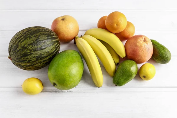 Various fruits on white wooden background. — Stock Photo, Image