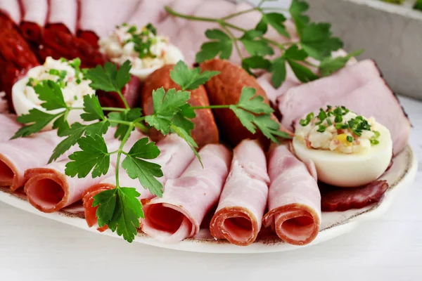 Plate with sliced ham and stuffed eggs. — Stock Photo, Image