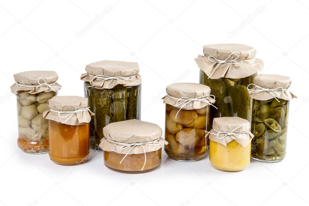 Pickled vegetables and colorful jams in glass jars