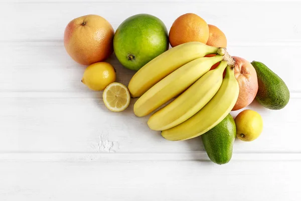 Various fruits on white wooden background. — Stock Photo, Image
