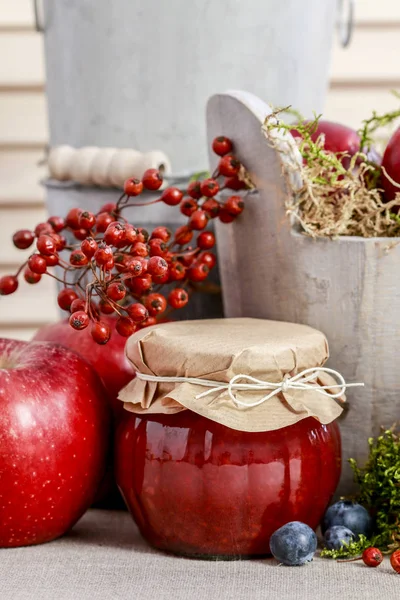 Glass jars with red jam. Autumn fruits around. — Stock Photo, Image
