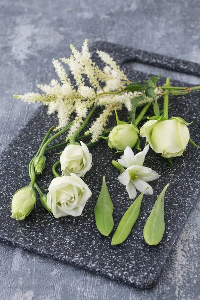 White and green flowers and other plants prepared for making flo