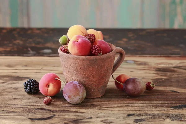 Винтажная кружка с цветными летними фруктами — стоковое фото