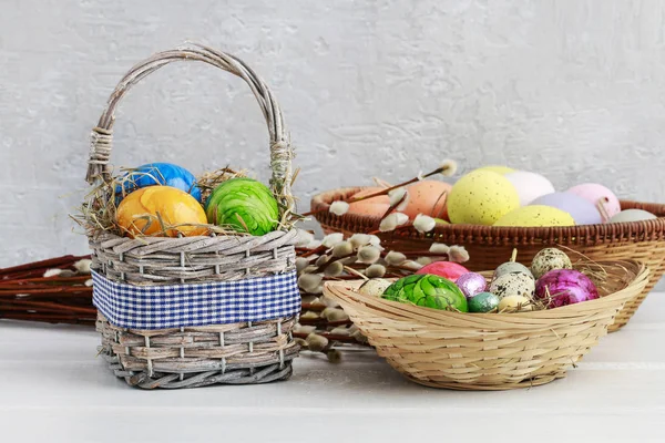 Huevos de Pascua de colores en la cesta de mimbre — Foto de Stock