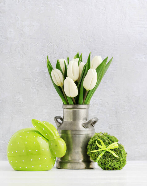 Easter decoration with green rabbit, egg made of moss and bouque