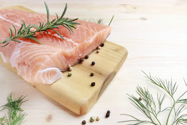 Raw salmon fillet on wooden background — Stock Photo, Image