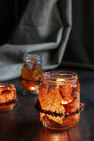 Herbstlaterne aus Glas mit bunten Blättern dekoriert — Stockfoto