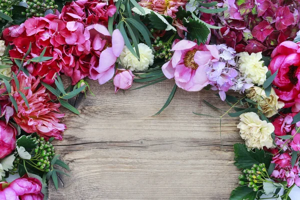 Florist's workspace - flowers and accessories on wood — Stock Photo, Image