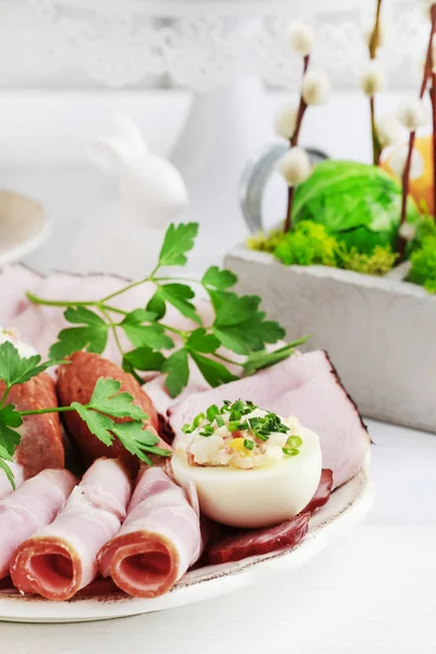 Plate with sliced ham and stuffed eggs. — Stock Photo, Image