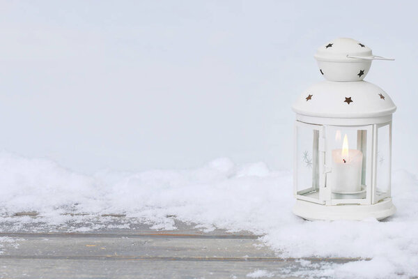 White iron lantern on snow. Winter wonderland