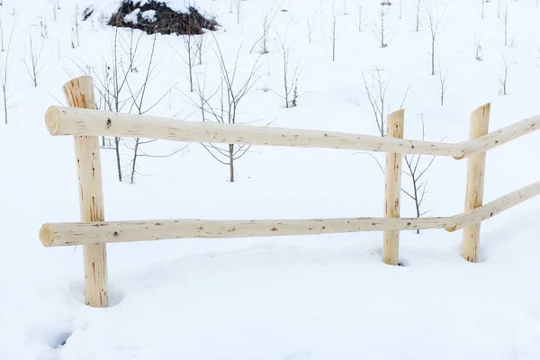 Wooden fence in winter.