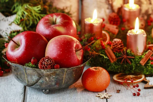 Cuenco con manzanas rojas entre las decoraciones navideñas . — Foto de Stock