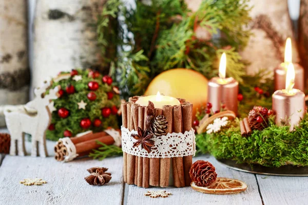 Candle decorated with cinnamon sticks — Stock Photo, Image