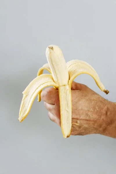 Man holding a banana.