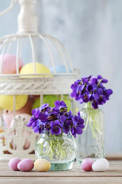 Buquê de violetas minúsculas (viola odorata) e ovo de Páscoa de chocolate — Fotografia de Stock