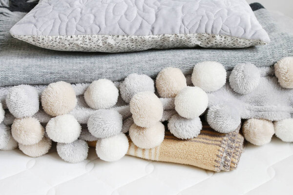 Beige blanket and bedsheet. 