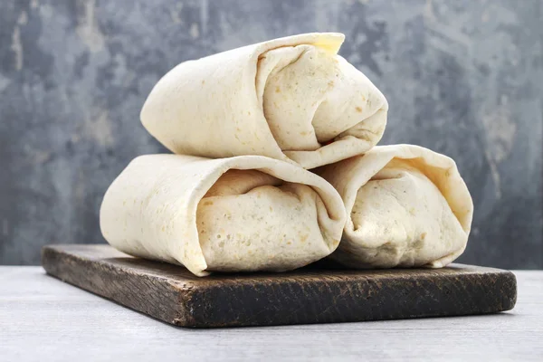A burrito - mexican dish that consists of a flour tortilla with — Stock Photo, Image