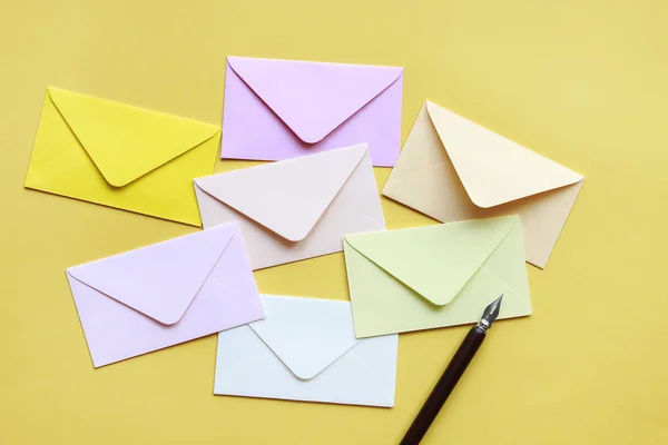 Colorful envelopes on yellow background — Stock Photo, Image