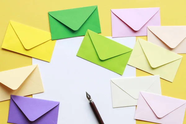 Colorful envelopes on yellow background — Stock Photo, Image