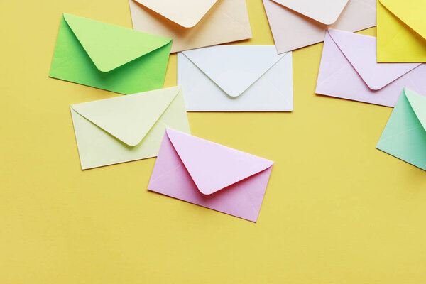 Colorful envelopes on yellow background