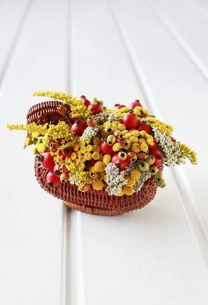 Bouquet of flowers in wicker goose. — Stock Photo, Image