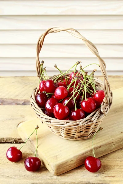 Basket of cherries on wooden table. — Stock Photo, Image