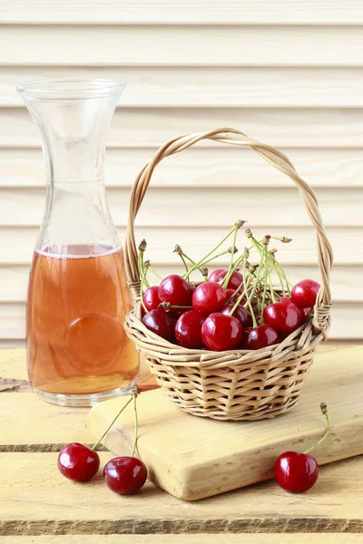 Basket of cherries on wooden table. — Stock Photo, Image