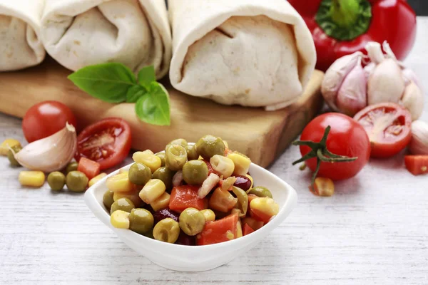 A burrito - mexican dish that consists of a flour tortilla with — Stock Photo, Image