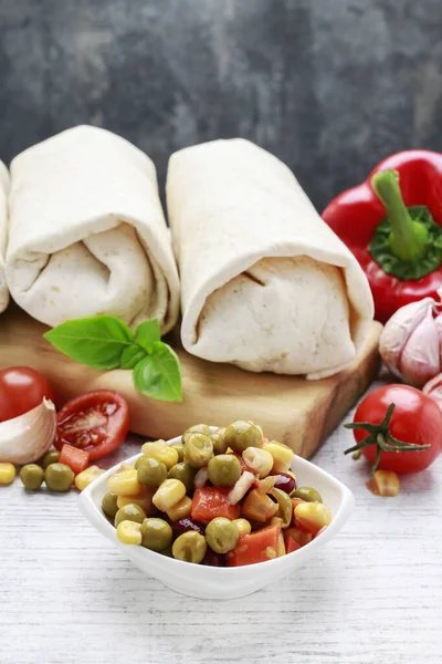 A burrito - mexican dish that consists of a flour tortilla with — Stock Photo, Image