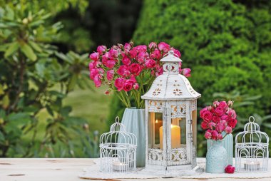 Çiçek masa düzenleme pembe güller ve romantik fenerler. 