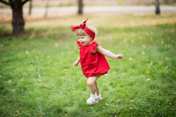 Маленькая Блондинка Красном Платье Улыбается Бегать Зеленой Траве — стоковое фото