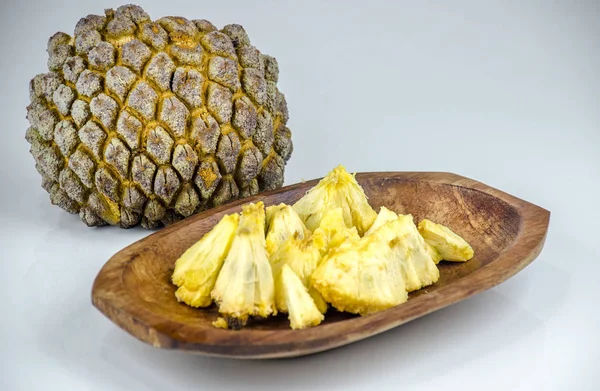 Edible part of marolo,  araticum or bruto fruit  on wooden bowl . Tropical  fruit of the original inhabitants of Brazil and Paraguai. Scientific name ; Annona crassiflora.