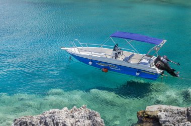 Resimli turkuaz Stoufis plajındaki sürat teknesi. Yunanistan 'ın Zakynthos adasının kuzey doğu kıyısında yer almaktadır..