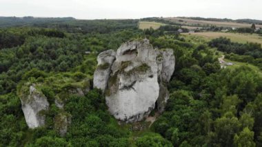 Arial view on a hole in the rock. Rocks. Forest in background. 4K, UHD, Cinematic