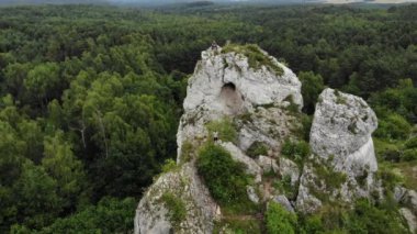 Arial view on a hole in the rock. Rocks. Forest in background. 4K, UHD, Cinematic