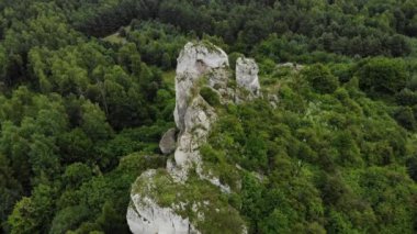 Arial view on a hole in the rock. Rocks. Forest in background. 4K, UHD, Cinematic