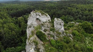 Arial view on a hole in the rock. Rocks. Forest in background. 4K, UHD, Cinematic