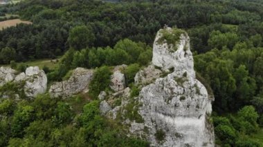 Arial view on a hole in the rock. Rocks. Forest in background. 4K, UHD, Cinematic