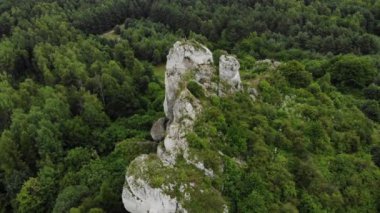 Arial view on a hole in the rock. Rocks. Forest in background. 4K, UHD, Cinematic