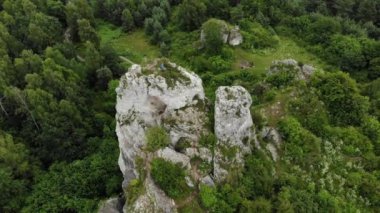 Arial view on a hole in the rock. Rocks. Forest in background. 4K, UHD, Cinematic