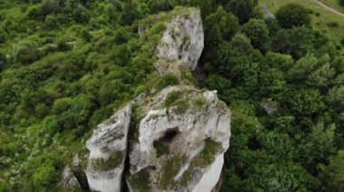 Arial view on a hole in the rock. Rocks. Forest in background. 4K, UHD, Cinematic