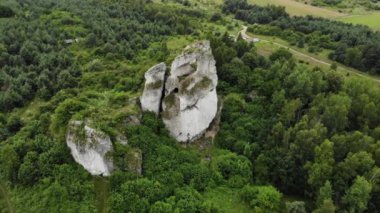 Arial view on a hole in the rock. Rocks. Forest in background. 4K, UHD, Cinematic